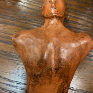 Hand carved wooden sculpture of a man. About the size of my hand